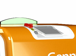 Zoom in on the top of an orange box. At the rounded upper edge, there is a white area. In this area is a small screen and to the left of it a red button.