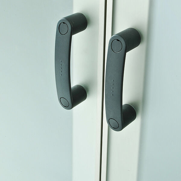 This is a closeup photo of the double door handles on the Material Transfer Hatch Passive C