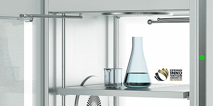 On a shelf are an Erlenmeyer flask with blue liquid and an empty beaker.