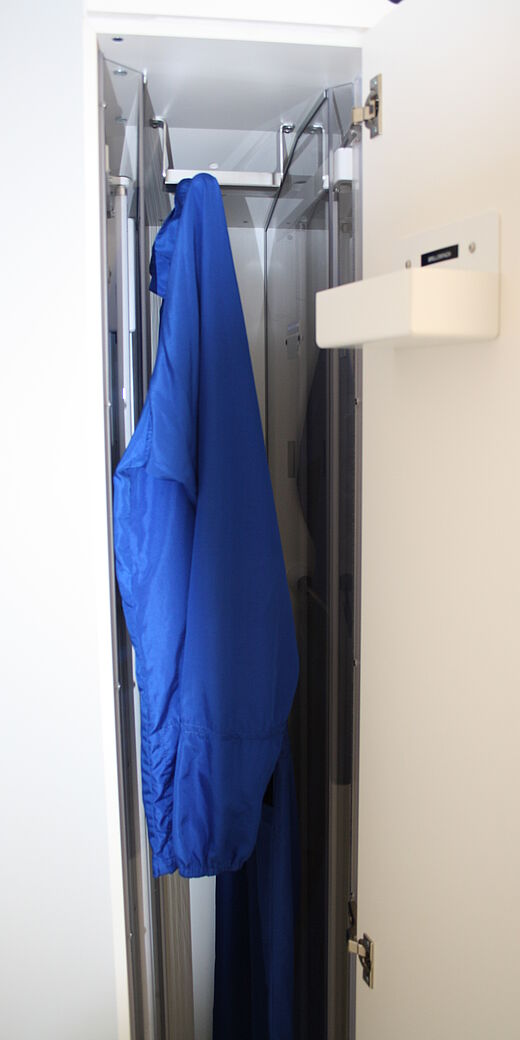 A dark blue protective material clothing in the closet 